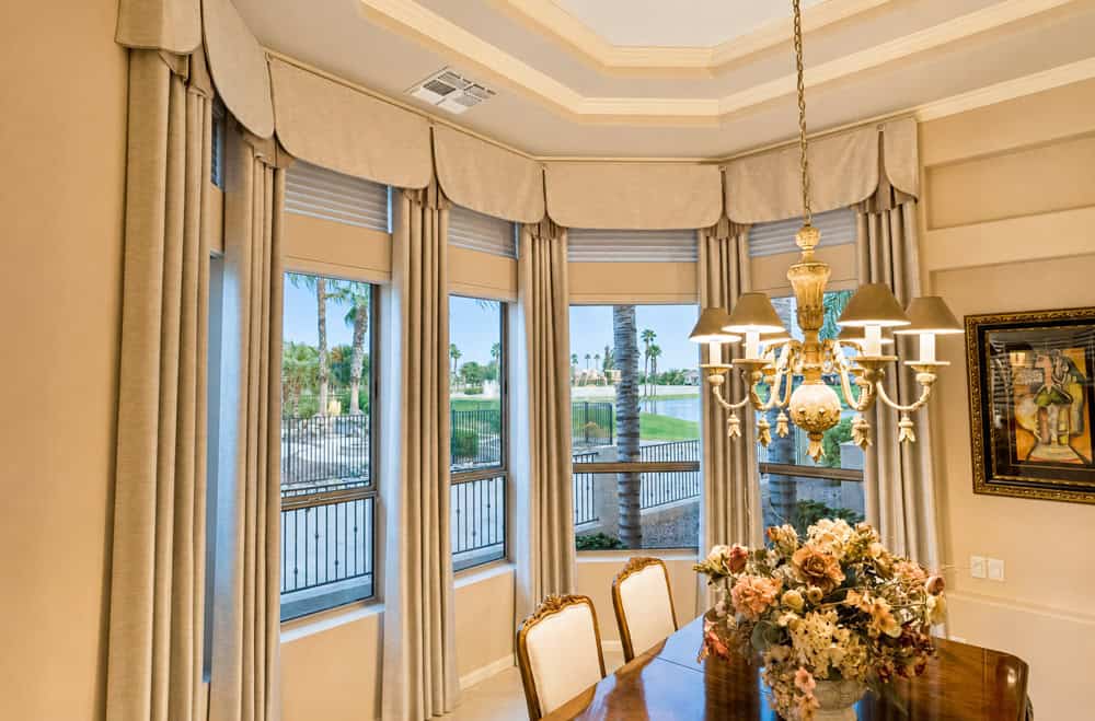 Full View of Angled Window with Flat Valances and Drapery 2017 First Place Specialty Window Fashions