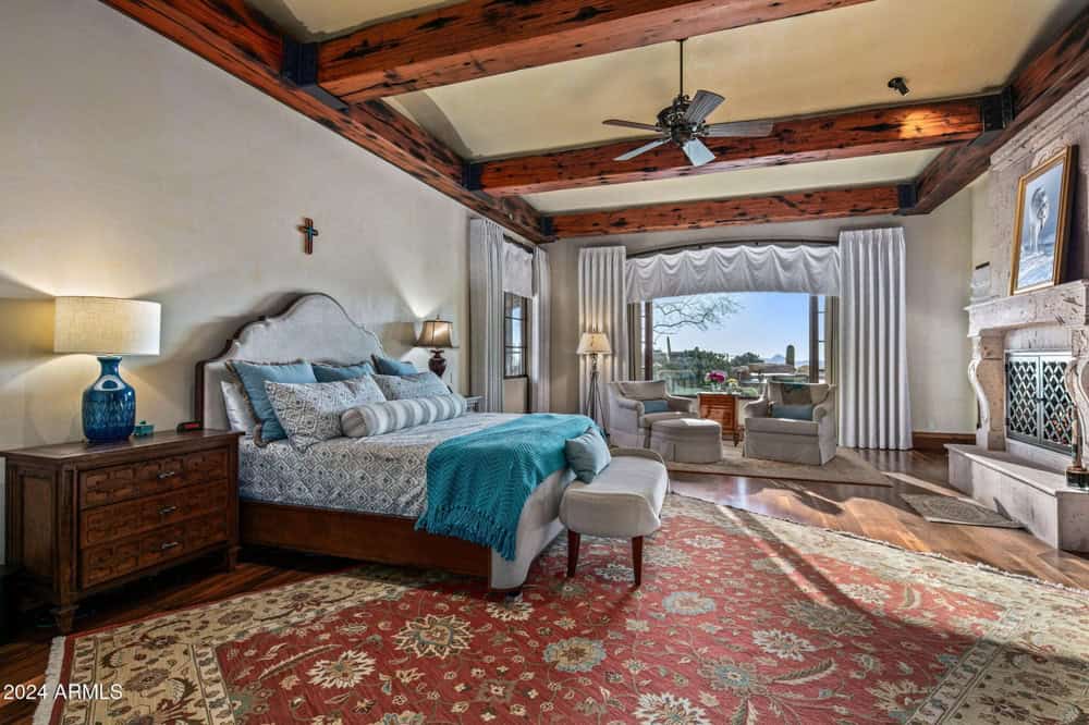 Master Bedroom with Custom Upholstered Headboard Fabric Duvet with Custom Accent Pillows and Bed Throw with Ottoman at the Foot of the Bed